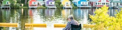 row of colourful cottages on lake