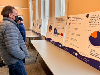 person looking at the display boards at the event