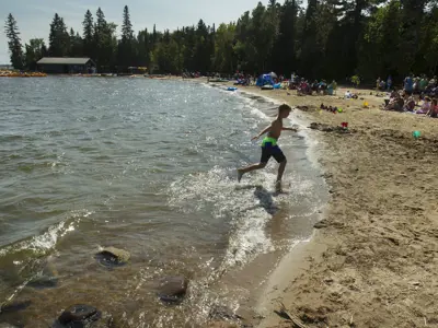 Beach with a child running out of the water