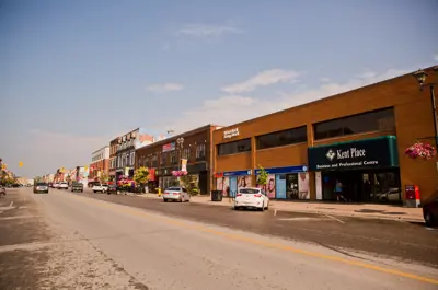 Road with business buildings and cars parked