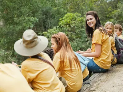 camp leader with her campers at a lookout during one of their outdoor adventures