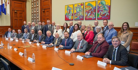 group photo at Queens Park- seated at board table