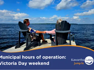 Municipal hours of operation for Victoria Day (May 19) with a couple sitting at the end of their dock
