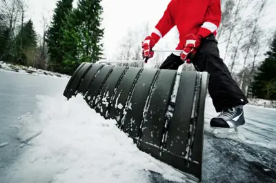 Outdoor Ice Rink Volunteer shovelling