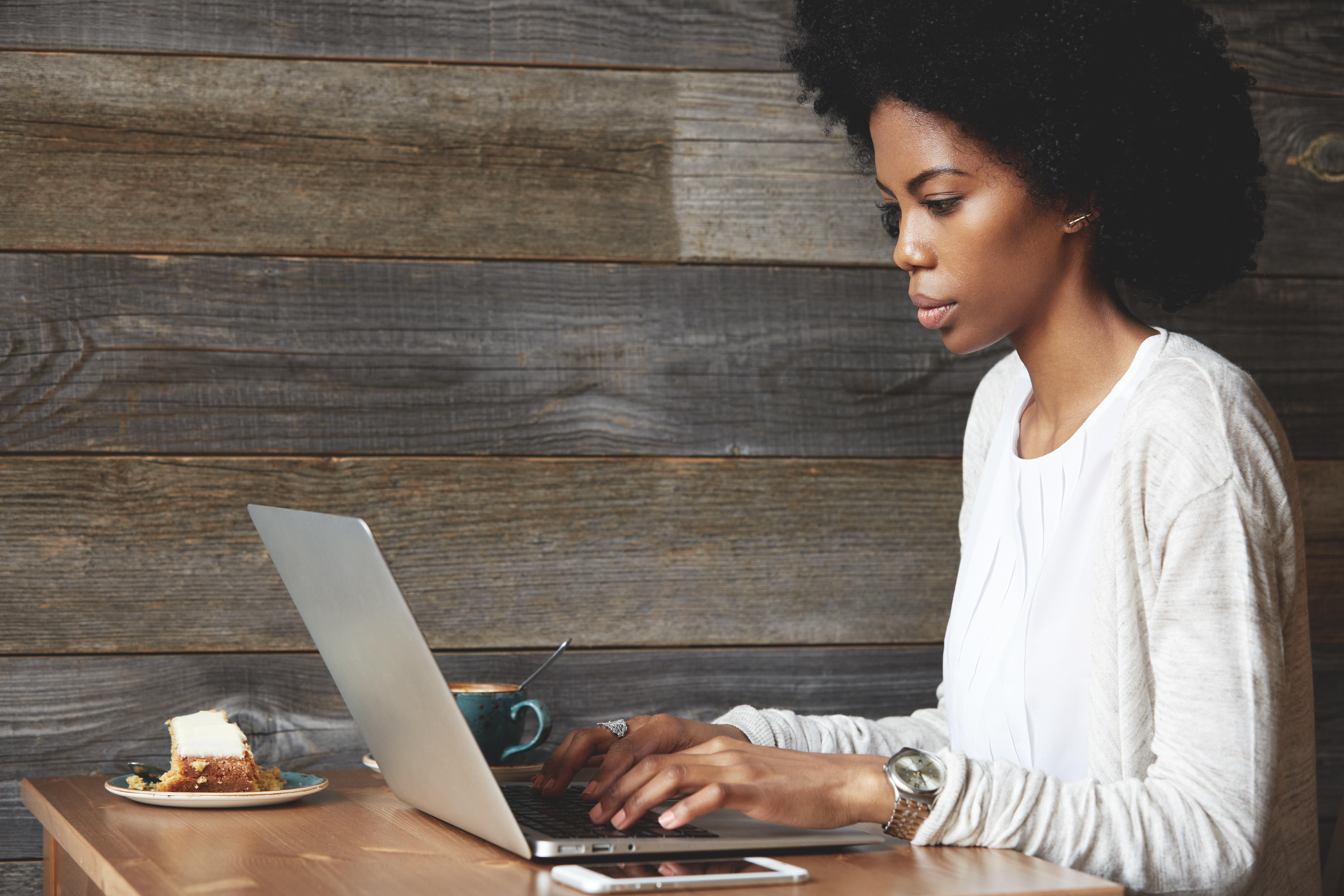 Woman working on laptop in coffee shop