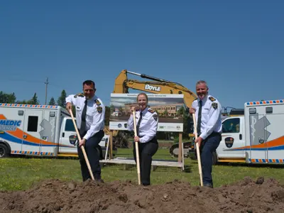 Paramedic chiefs posing with shovels at groundbreaking ceremony