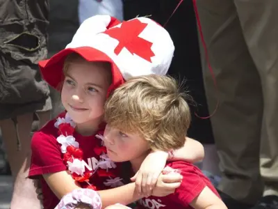 Two children dressed in Canada Day clothing at a parade