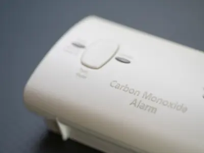 Image of a carbon monoxide alarm on a grey background