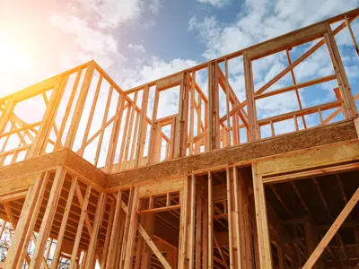 The frame of a house against a blue sky