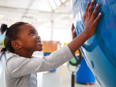 camper discovering new places in the world looking at a large globe