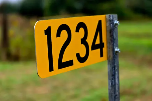 Yellow 911 sign with numbers 1234 on it