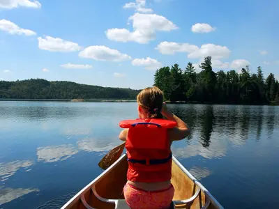 Young girl canoeing in a lifejacket