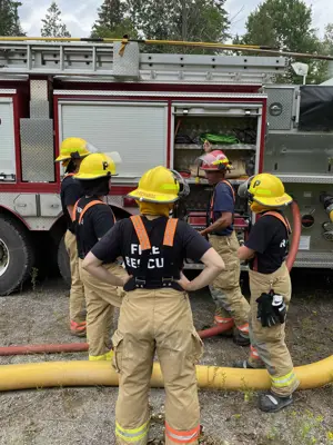 Volunteer firefighters learn the ins and outs of a fire truck