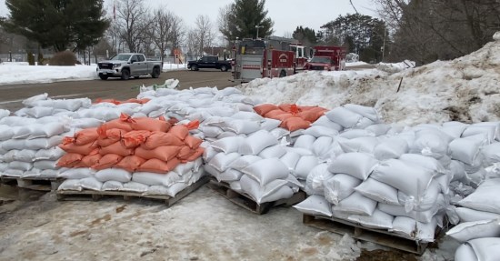 pre-filled sandbags on skids outside of a community centre
