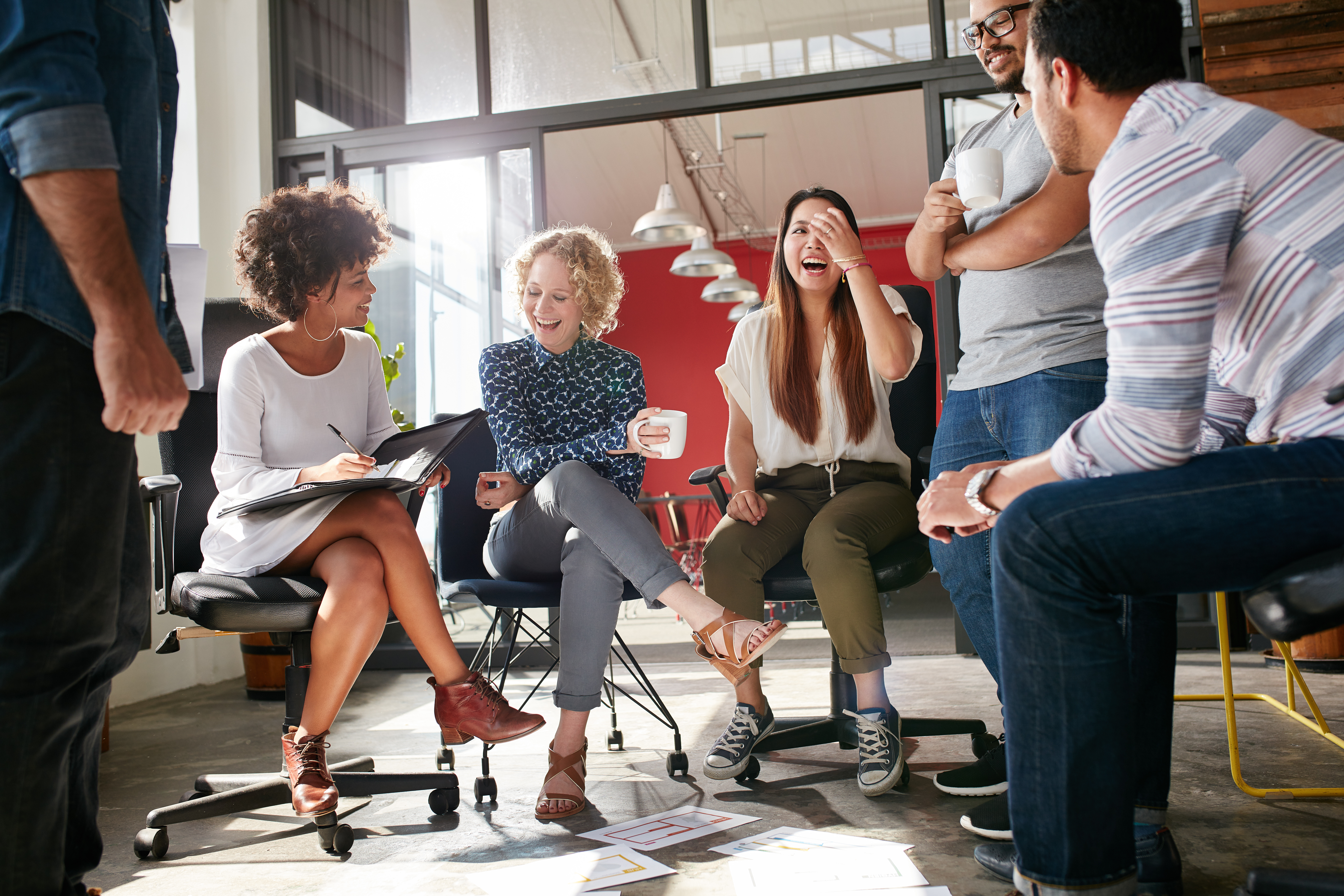 People sitting in a circle laughing and talking with each other