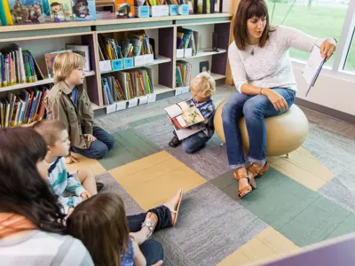 Woman reading to group of children