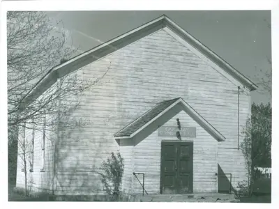Black and white historic photo of white hall shown from the front door.