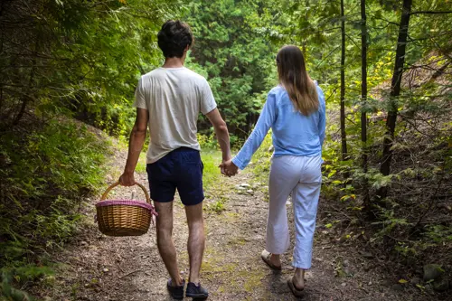 image of man and woman walking on trail