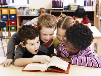 kids looking at a book together