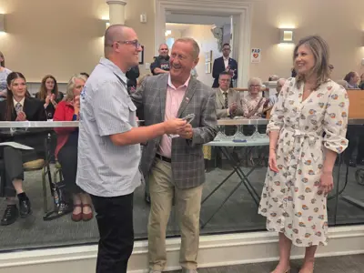 Photo of a man accepting an award.