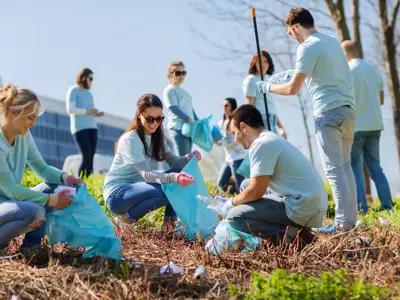 A group of community members pick up litter together