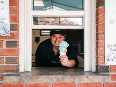 Ice cream being served by smiling woman