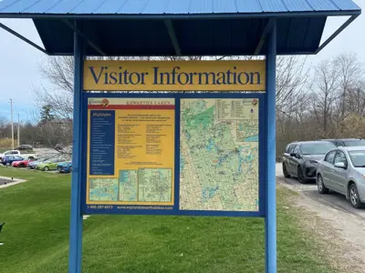 Visitor Information sign with map and blue roof outside