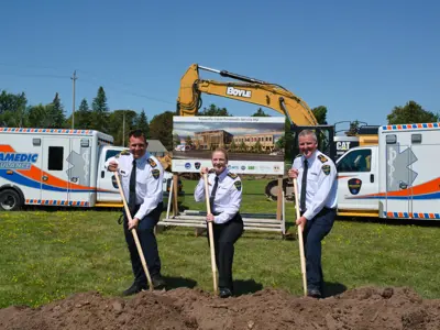 Paramedic chiefs posing with shovels at groundbreaking ceremony