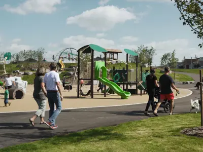 Park playground with people walking on walkway