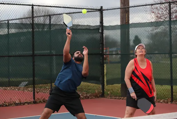 Couple playing pickleball