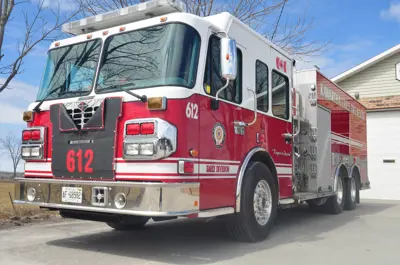 Red firetruck parked on grey pavement