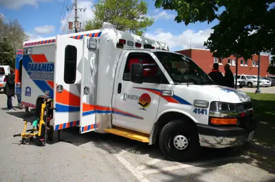 Ambulance parked on pavement with side door open