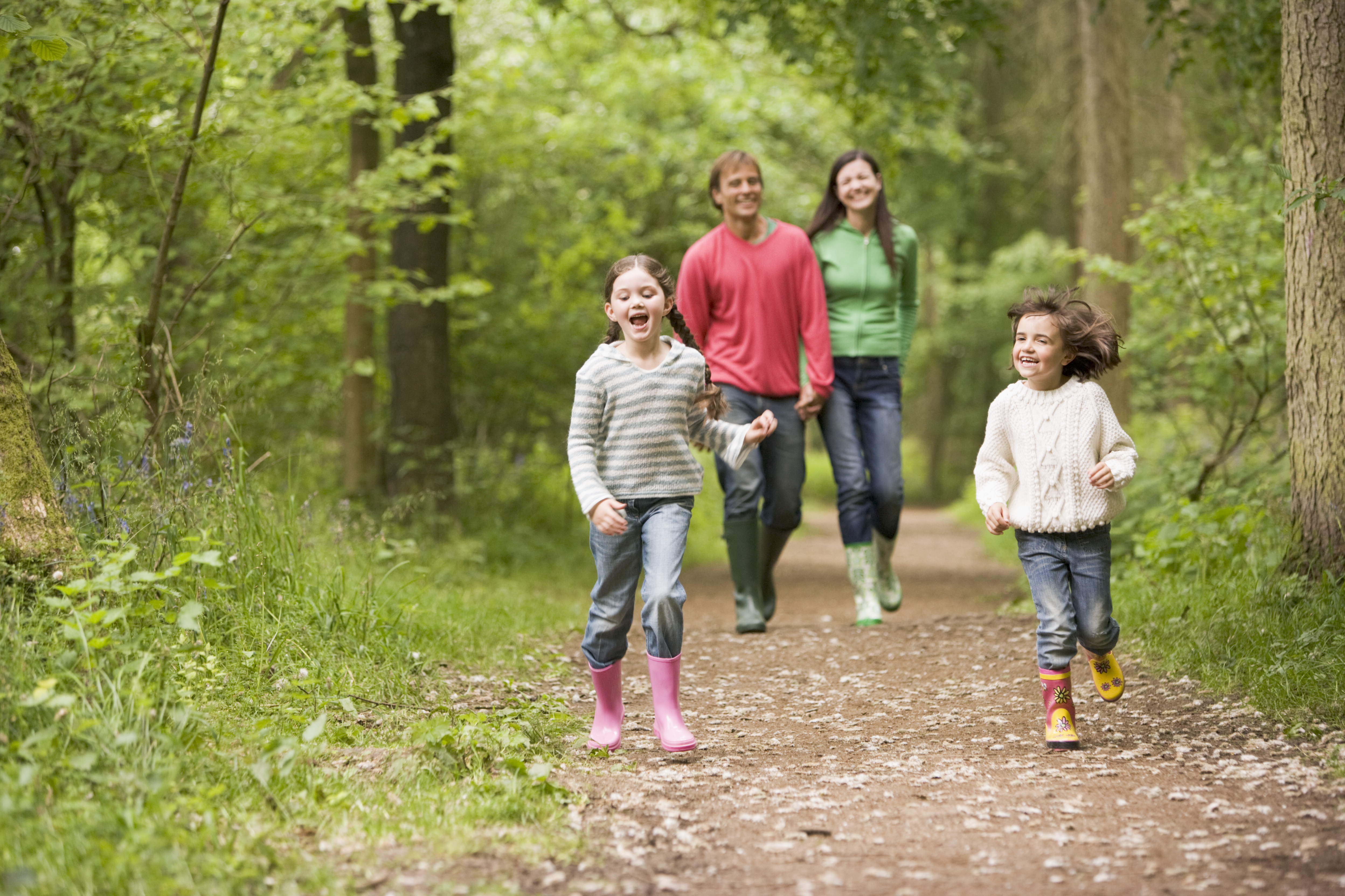 Family Walking On Trail in the middle of the woods