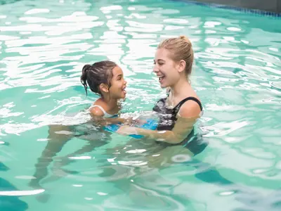 Swim instructor and child in pool 