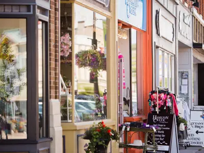 Row of shops with signs and flowers in front