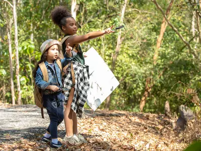 children looking at a map and discovering how to follow directions 