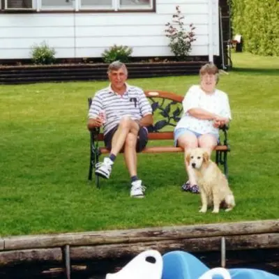 Cliff and Barbara Hooey sitting on a bench by the lake