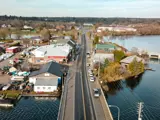 Aerial view of town with road going through the middle and water on either side