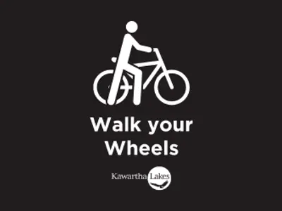 Black and white icon of person walking bike
